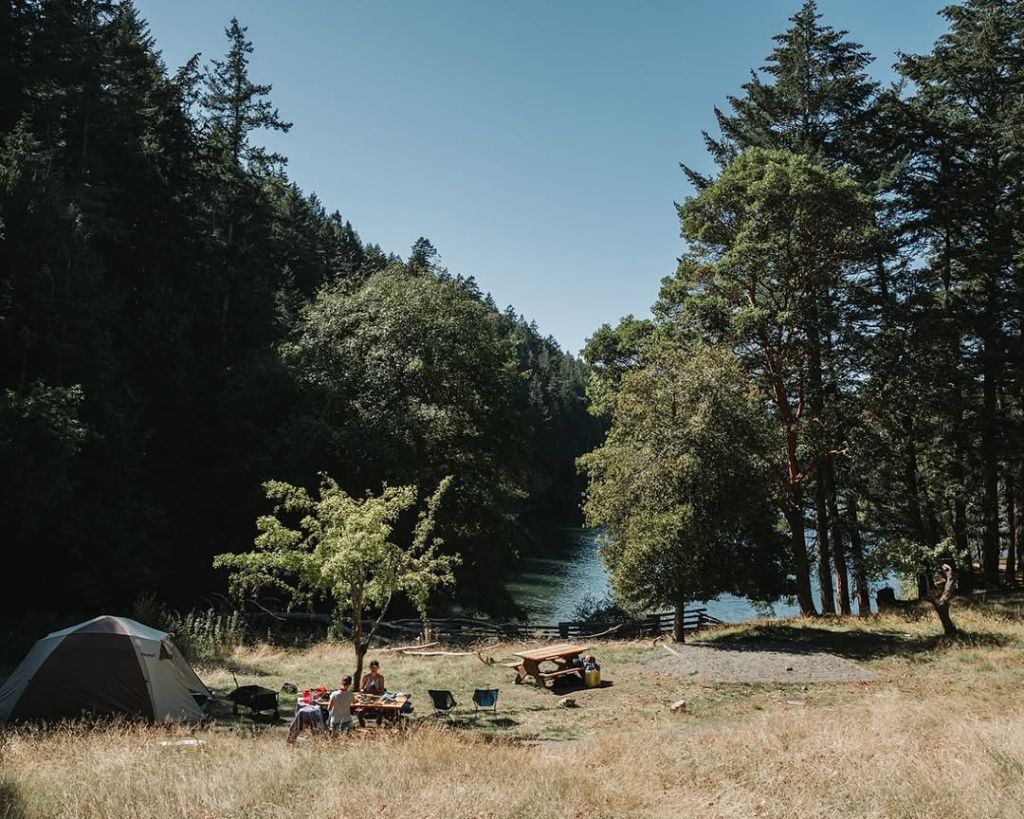 Southern Gulf Islands Camping while paddling. Picture showing campers set up on a beautiful campsite on Saturna Island